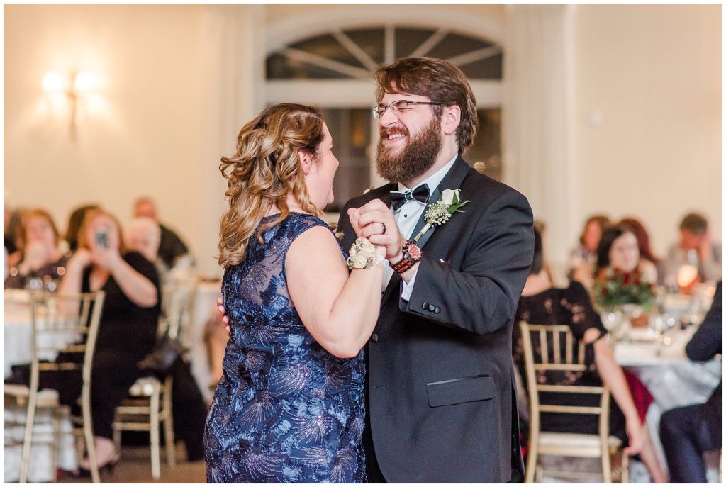mother of the groom and her son are slow dancing