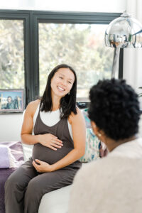 pregnant woman being helped by a doula