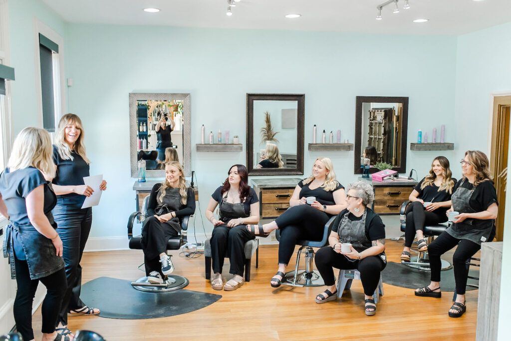 hair salon team sitting together during a meeting