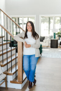 real estate agent standing near the stairwell of a house