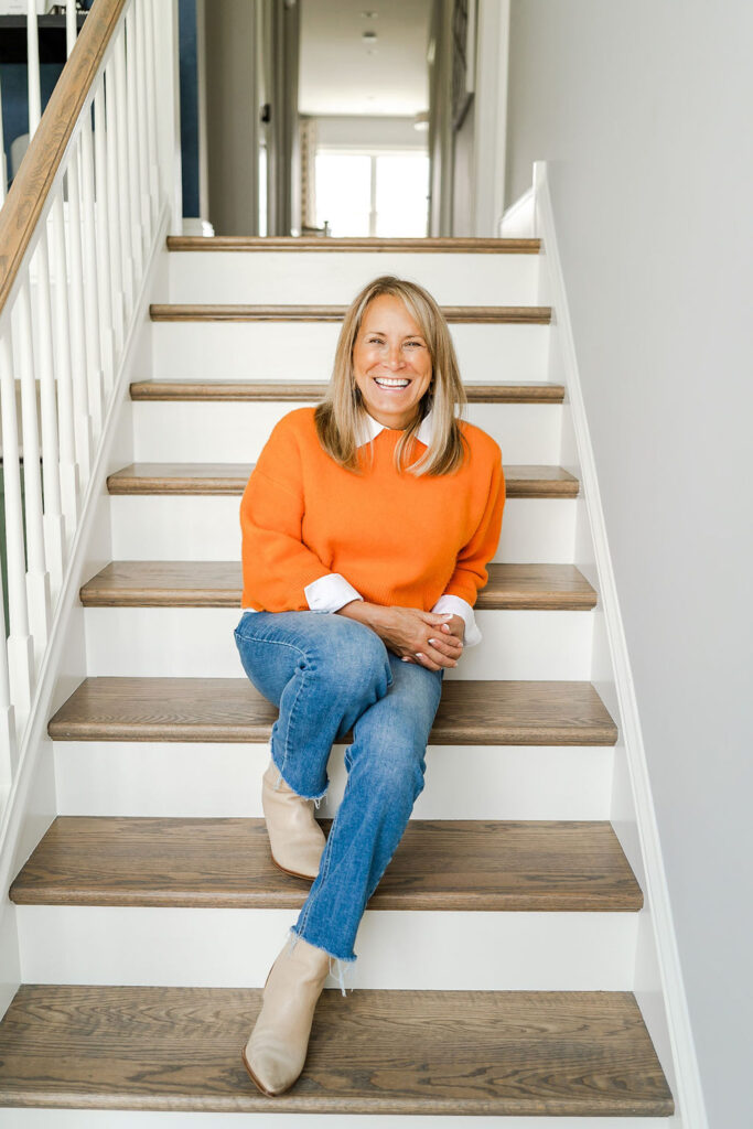 realtor sitting on steps while smiling during a branding session