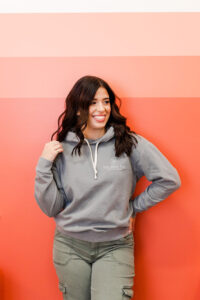 woman in a gray sweatshirt during a tattoo artist branding session