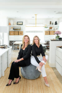 two women sitting on a chair and smiling during an interior designer branding session