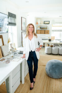 woman in white top and black pants smiling during an interior designer branding session