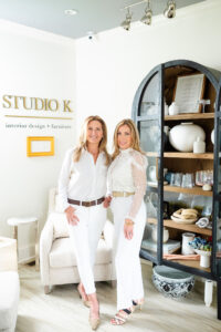 two women in white smiling in an interior designer studio during a branding session