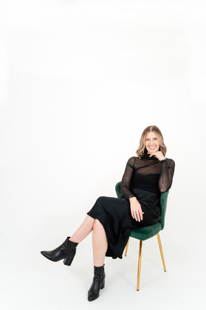 woman in black sitting in a chair during a bridal beauty branding session