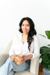 art therapist smiling while sitting in a chair during an art therapist branding session