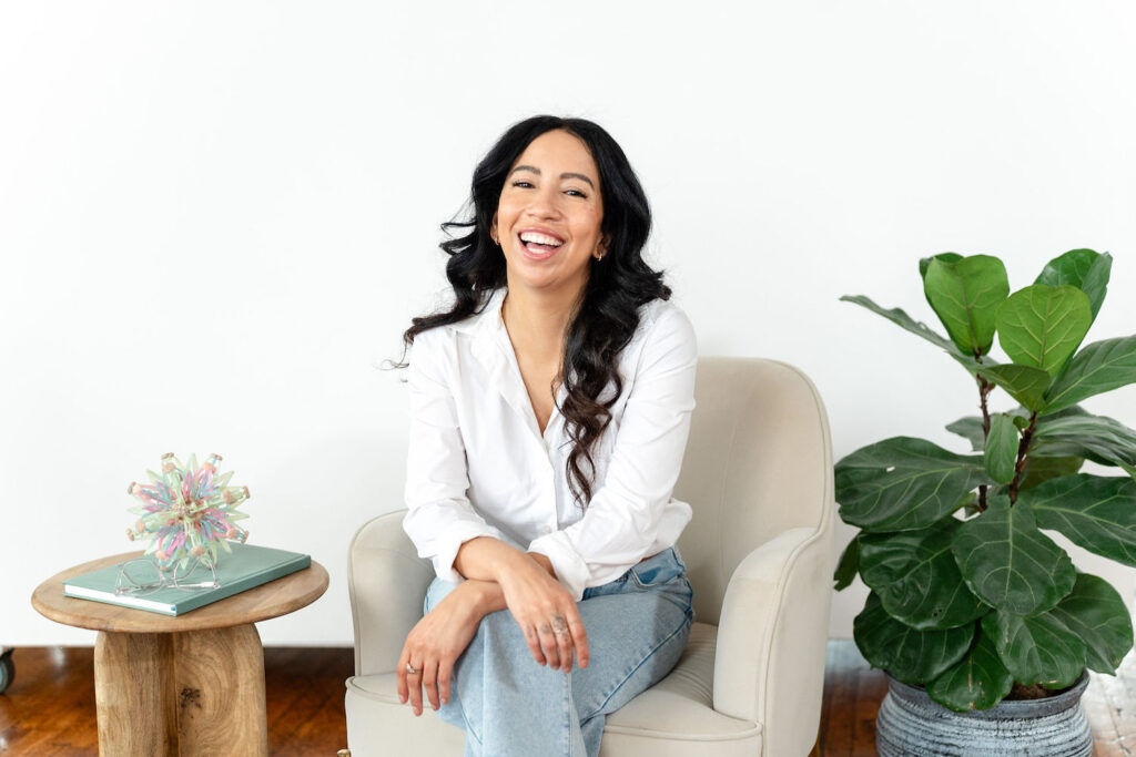 art therapist laughing while sitting in a chair